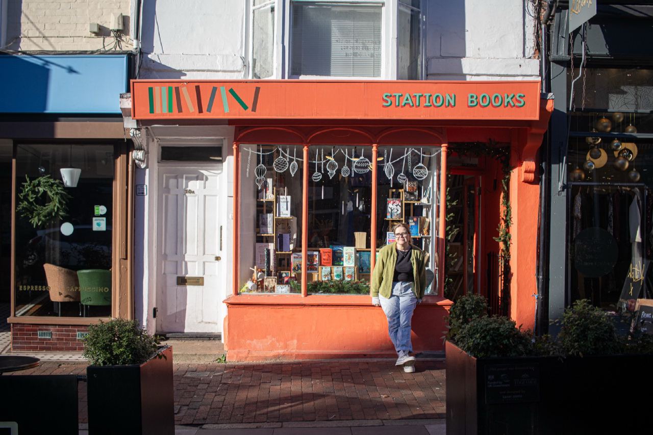 The Station Books shopfront on the high street in Tunbridge Wells, with one of the owners standing in the doorway